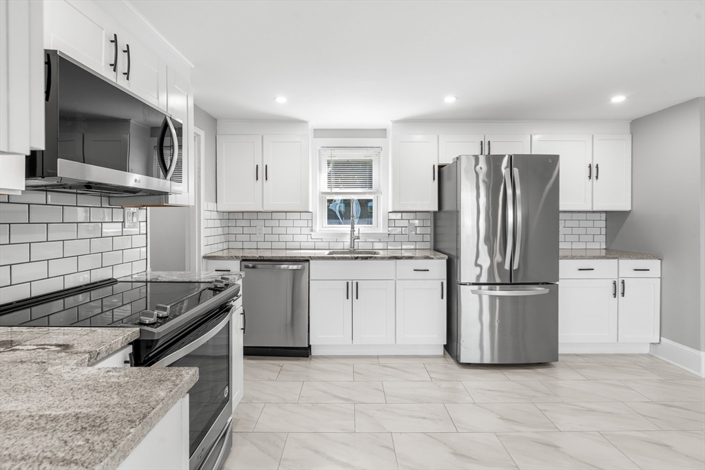 212 Cambridge Road Woburn, MA 01801 - Photo 10 of 25 a kitchen with a refrigerator stove and microwave