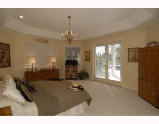 2855 Paddock Road Weston, FL 33331 - Photo 11 of 16 a room with furniture and a chandelier