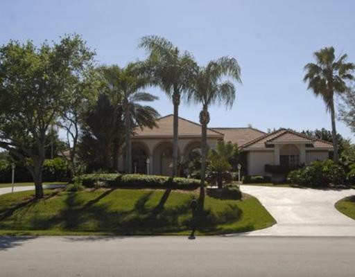 2855 Paddock Road Weston, FL 33331 - Photo 2 of 16 a front view of a house with a yard and palm trees