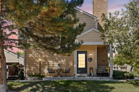 a front view of a building with lake view and trees