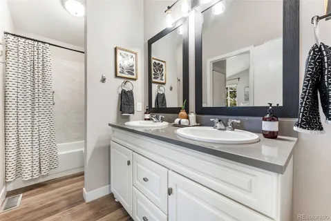 a bathroom with a double vanity sink and a mirror