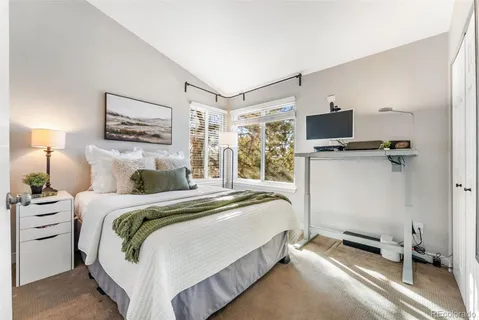 a bedroom with a bed and a desk