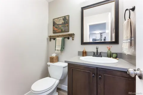 a bathroom with a toilet a sink and mirror