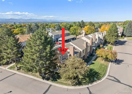 an aerial view of a house with a yard and lake view