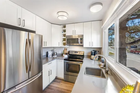 a kitchen with stainless steel appliances a stove sink microwave and cabinets