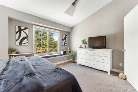 a bedroom with a bed and a tv