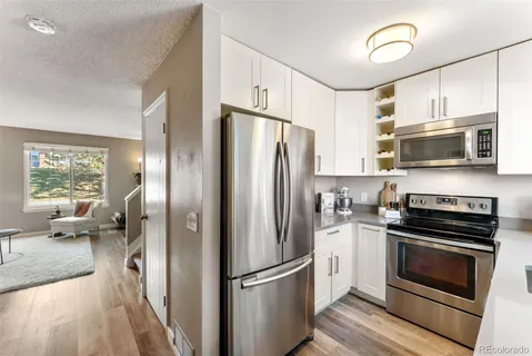a kitchen with stainless steel appliances a refrigerator stove and microwave