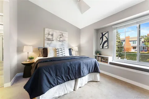 a bedroom with a bed and a large window