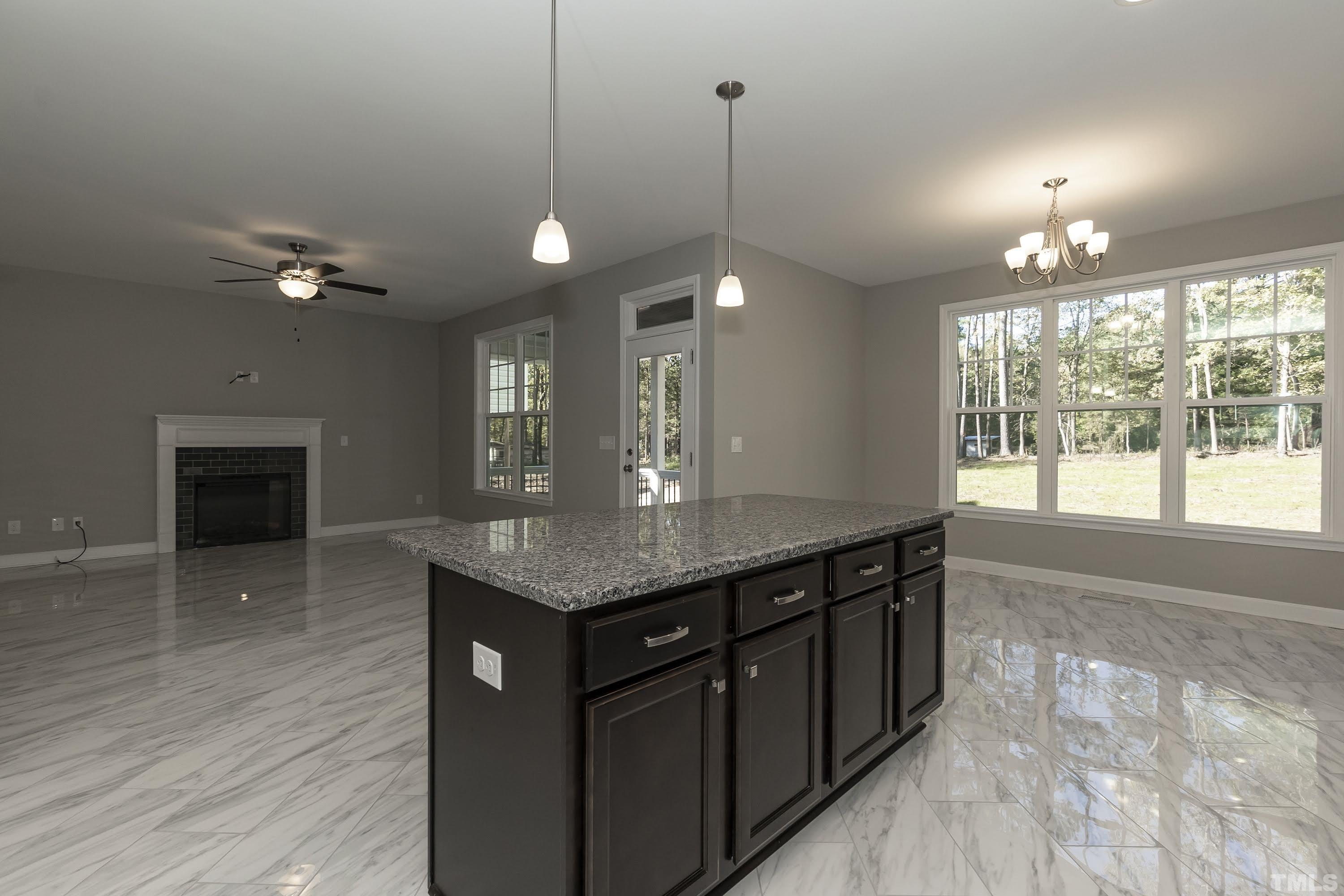 6002 East Pool Road Rougemont, NC 27572 - Photo 11 of 23 a kitchen with a stove a sink and wooden floor