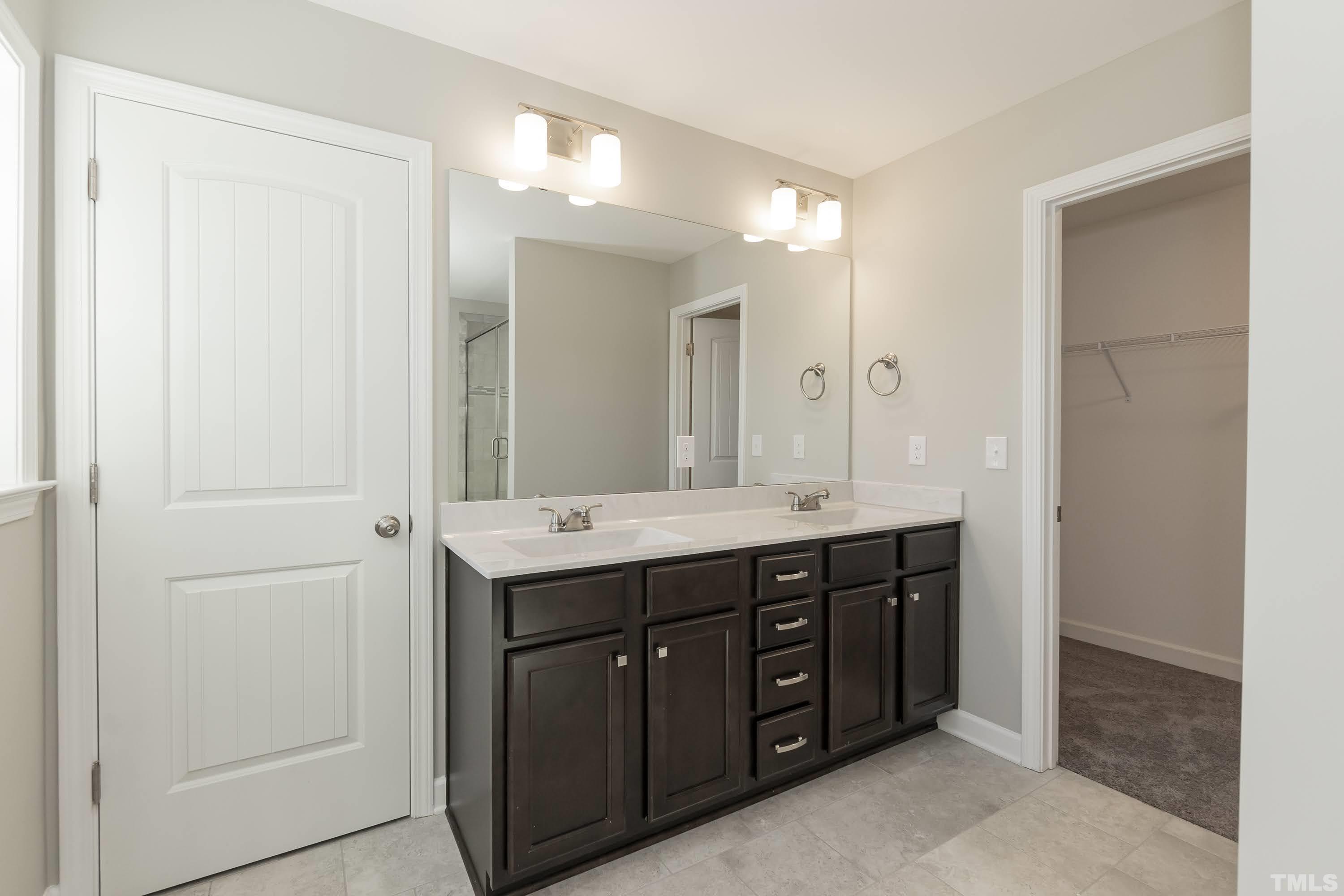 6002 East Pool Road Rougemont, NC 27572 - Photo 17 of 23 a spacious bathroom with a double vanity sink and a mirror
