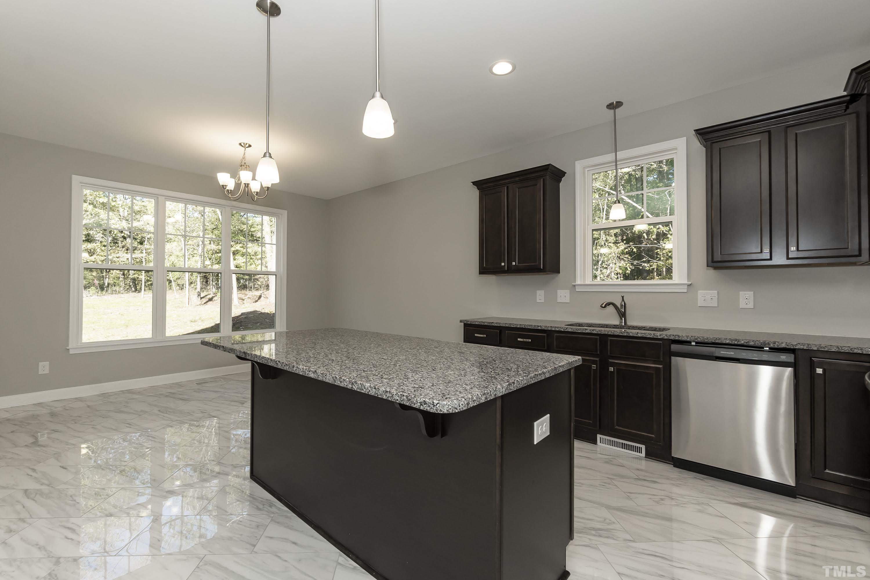 6002 East Pool Road Rougemont, NC 27572 - Photo 8 of 23 a kitchen with granite countertop a sink a counter space appliances and cabinets
