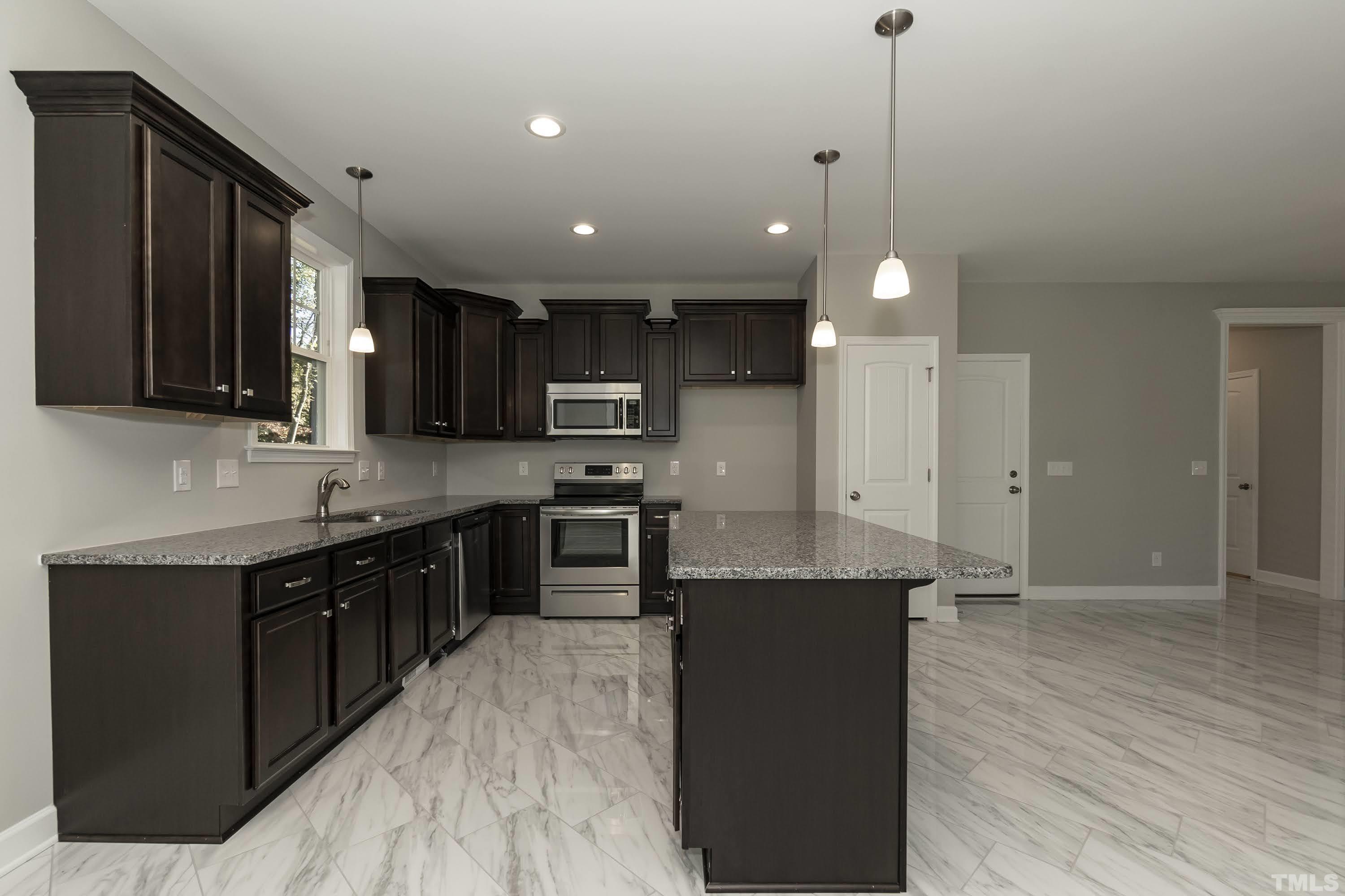 6002 East Pool Road Rougemont, NC 27572 - Photo 10 of 23 a kitchen with stainless steel appliances kitchen island granite countertop a stove a sink and a refrigerator