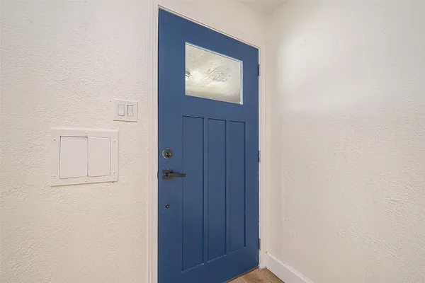 a view of front door with a bench and a window