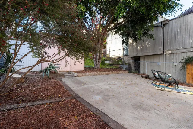 a view of a backyard with large tree