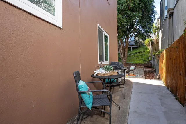 a view of a patio with table and chairs and potted plants