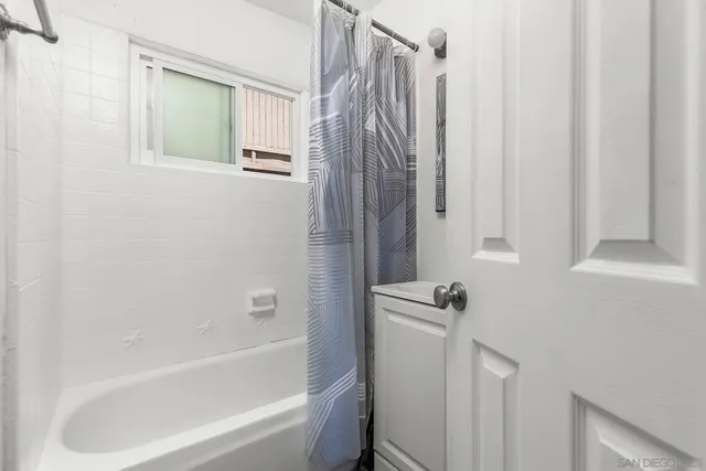 a bathroom with bathtub and a shower