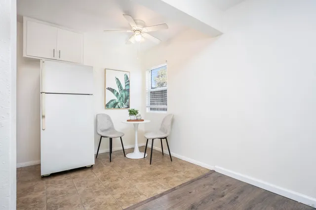 a view of a dining room with furniture and a chandelier