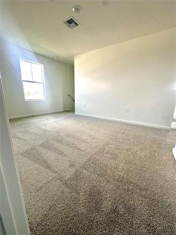 an empty room with a windows