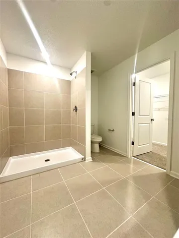 a bathroom with a glass shower door