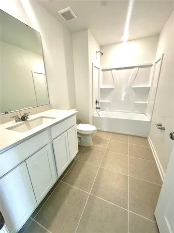 a bathroom with a granite countertop sink toilet a mirror and a shower