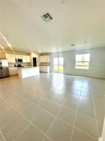 a view of a livingroom with furniture and an empty room