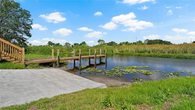 a view of a lake with houses in the back