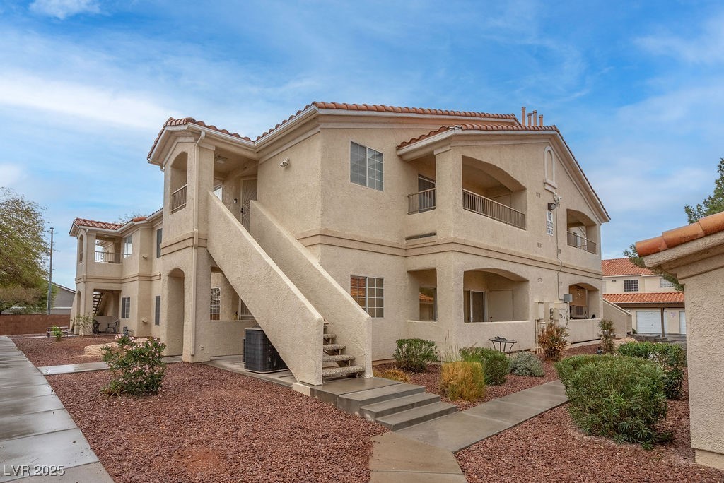 1881 West Alexander Road, Unit 1129 North Las Vegas, NV 89032 - Photo 1 of 31 View of building exterior featuring stairs