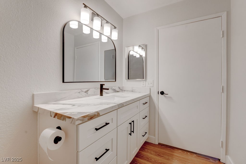 1881 West Alexander Road, Unit 1129 North Las Vegas, NV 89032 - Photo 10 of 31 Bathroom featuring light wood finished floors and vanity