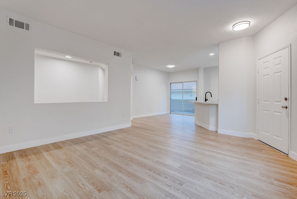 1881 West Alexander Road, Unit 1129 North Las Vegas, NV 89032 - Photo 11 of 31 Living room with new finished floors and recessed lighting