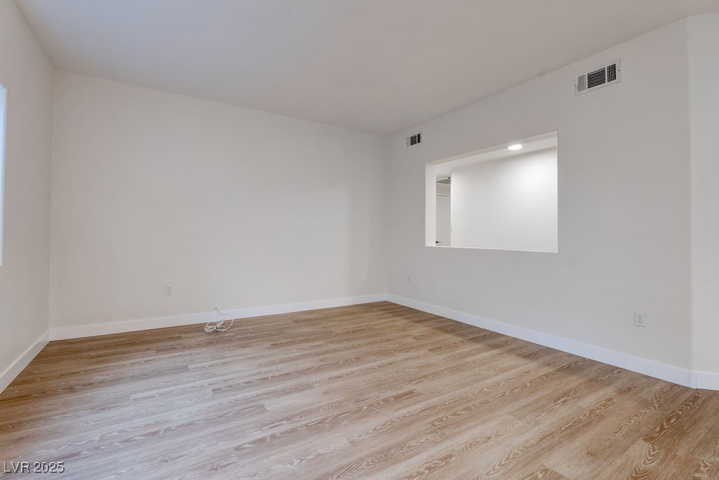 1881 West Alexander Road, Unit 1129 North Las Vegas, NV 89032 - Photo 14 of 31 Unfurnished room featuring light wood-style floors and baseboards