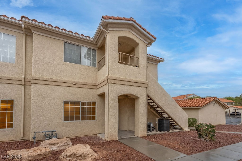1881 West Alexander Road, Unit 1129 North Las Vegas, NV 89032 - Photo 2 of 31 Mediterranean / spanish house with a balcony, stairway, stucco siding, and a tile roof