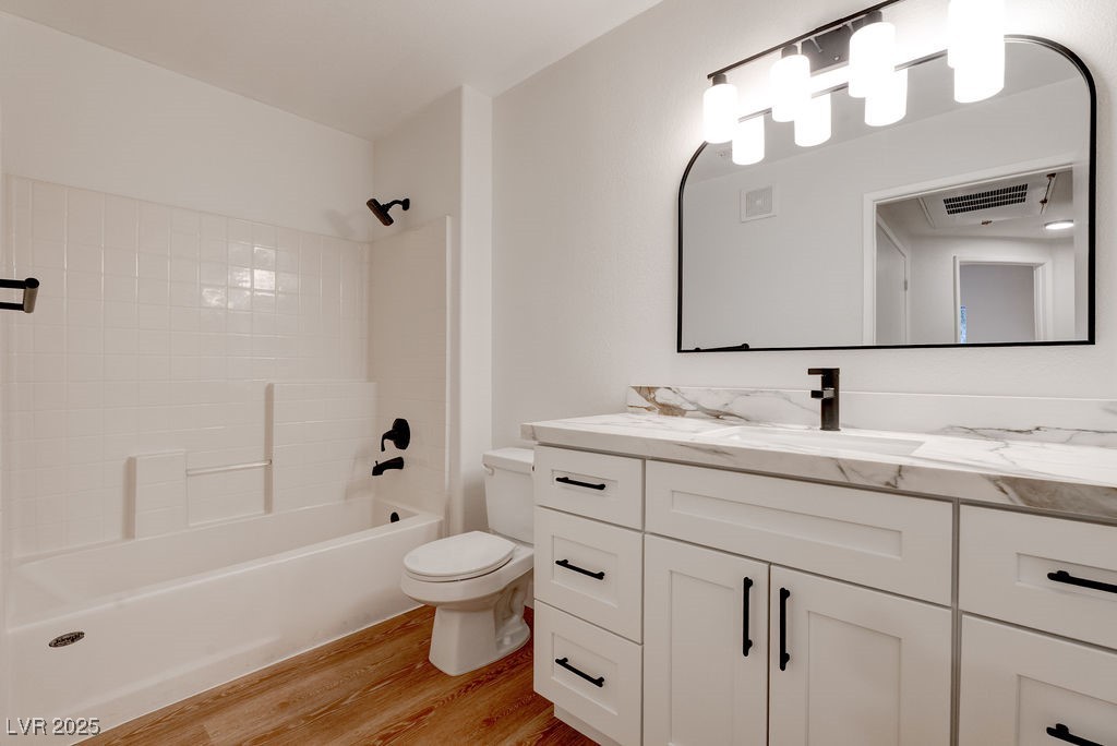 1881 West Alexander Road, Unit 1129 North Las Vegas, NV 89032 - Photo 25 of 31 Full bath featuring a textured wall, vanity, and light wood-style floors