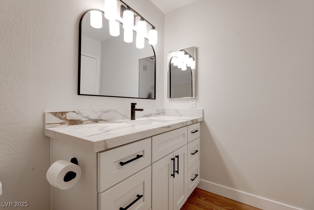 1881 West Alexander Road, Unit 1129 North Las Vegas, NV 89032 - Photo 26 of 31 Full bath featuring a textured wall, vanity, and light wood-style floors