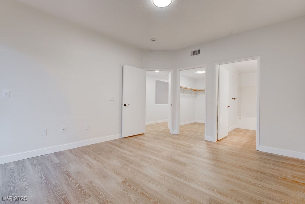 1881 West Alexander Road, Unit 1129 North Las Vegas, NV 89032 - Photo 7 of 31 Primary bedroom with light wood finished floors and a spacious closet