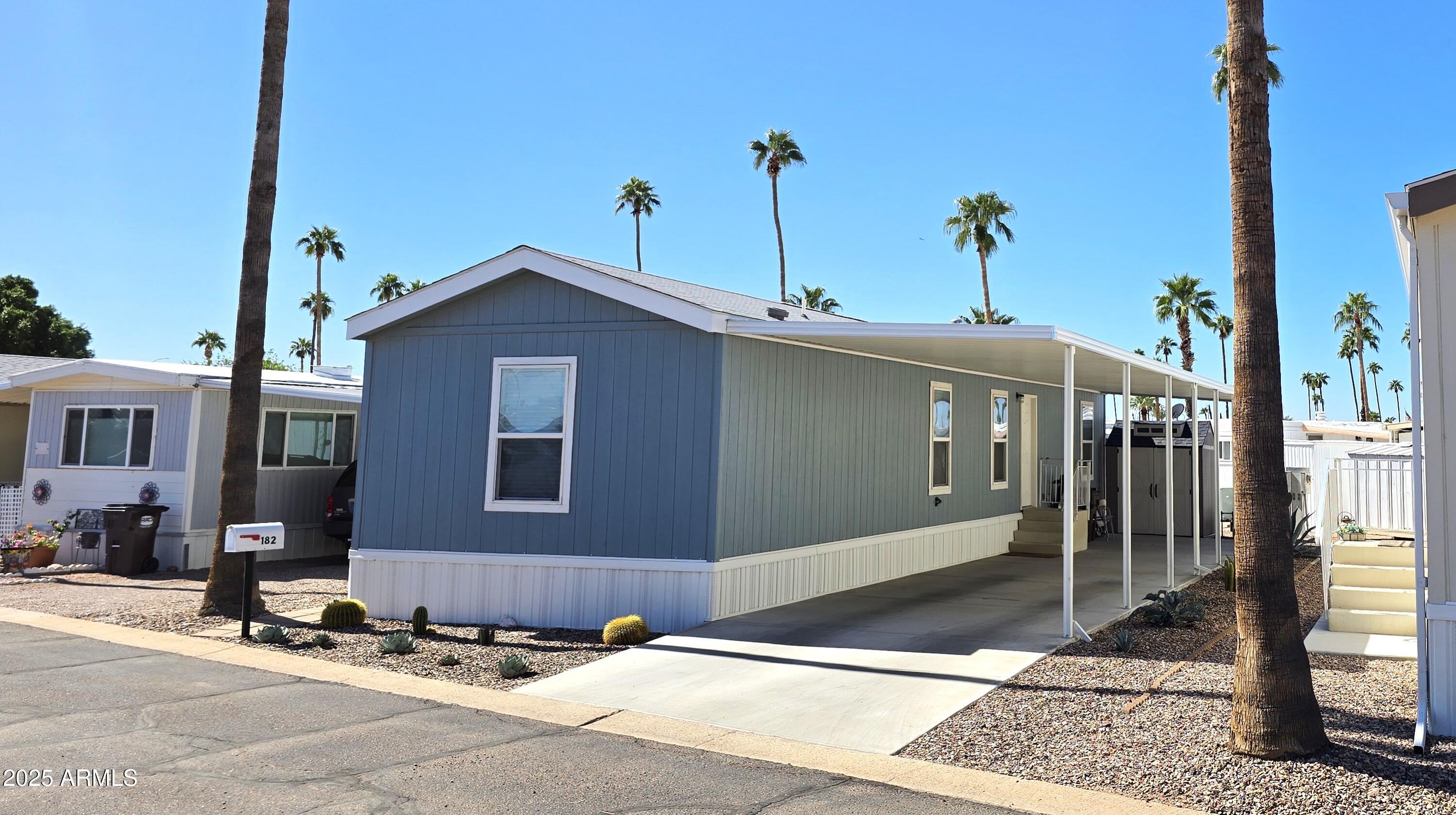 10540 East Apache Trail, Unit 182 Apache Junction, AZ 85120 - Photo 1 of 30 a front view of a house with a yard