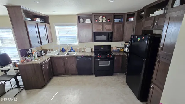 a kitchen with a refrigerator and a sink