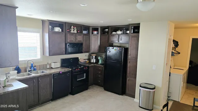 a kitchen with a refrigerator and a sink