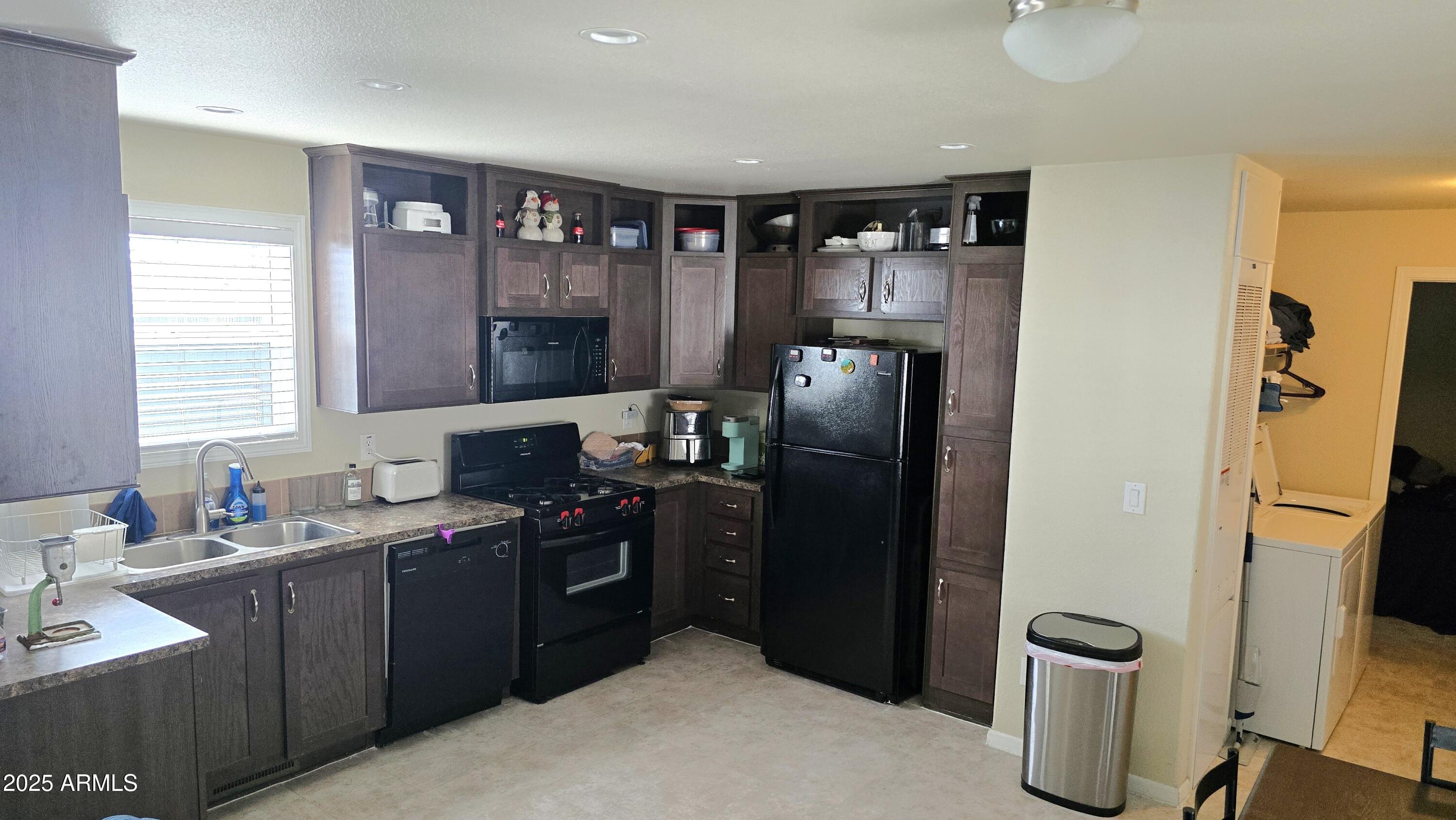 10540 East Apache Trail, Unit 182 Apache Junction, AZ 85120 - Photo 12 of 30 a kitchen with a refrigerator and a sink