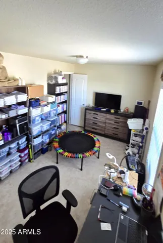 a living room with furniture a flat screen tv and a table
