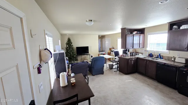 a living room with furniture a window and a flat screen tv