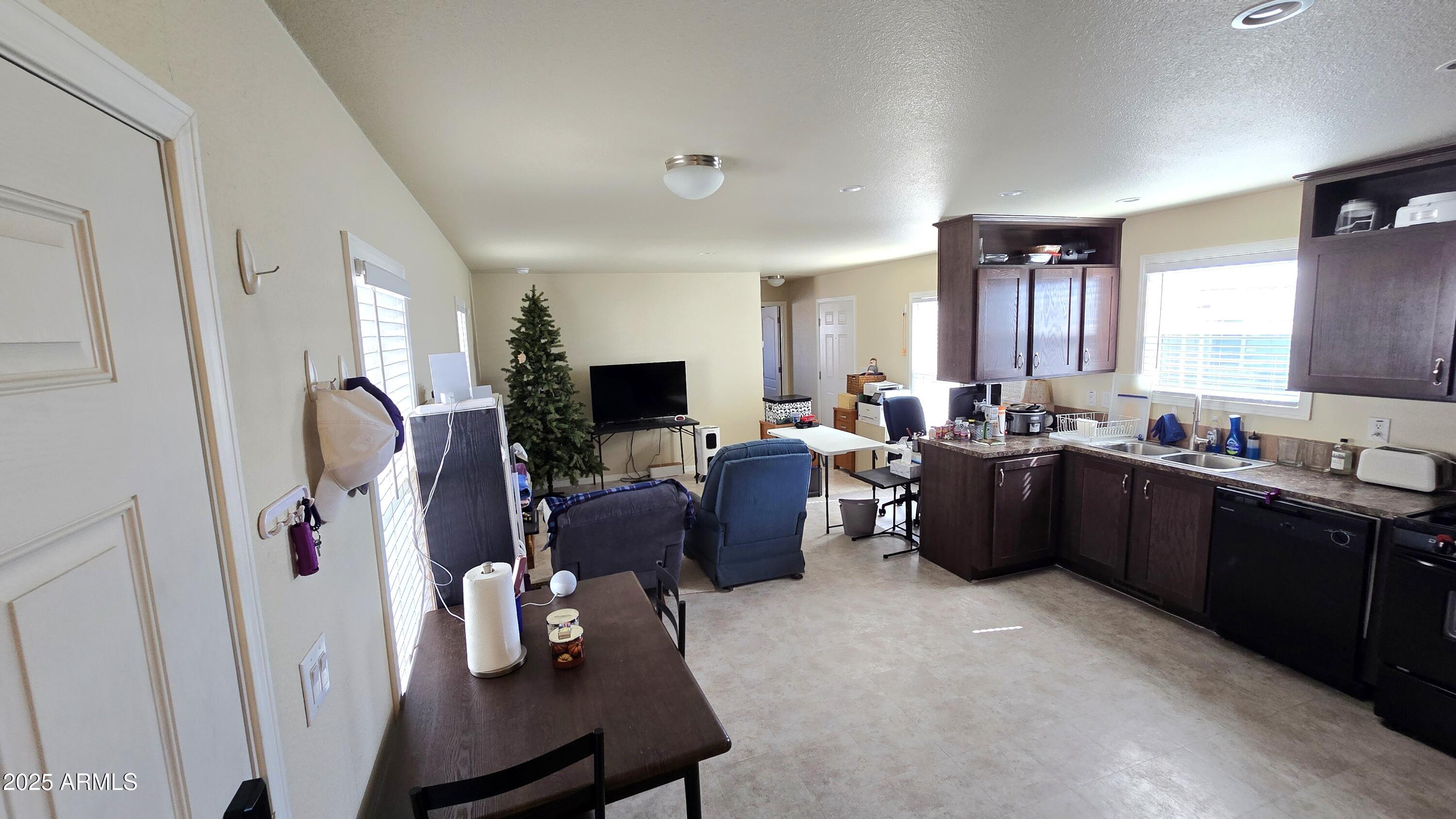 10540 East Apache Trail, Unit 182 Apache Junction, AZ 85120 - Photo 16 of 30 a living room with furniture a window and a flat screen tv