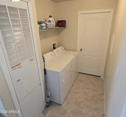 a utility room with a sink a washer and dryer