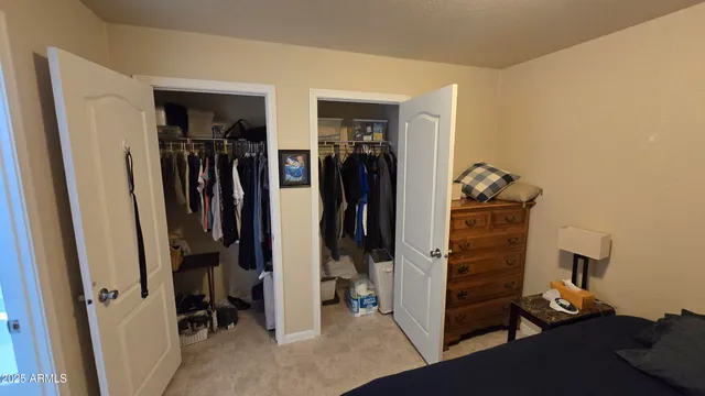 a view of walk in closet with clothes