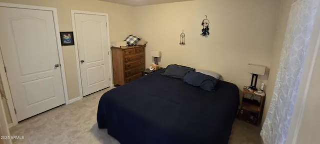 a bedroom with a bed and a dresser
