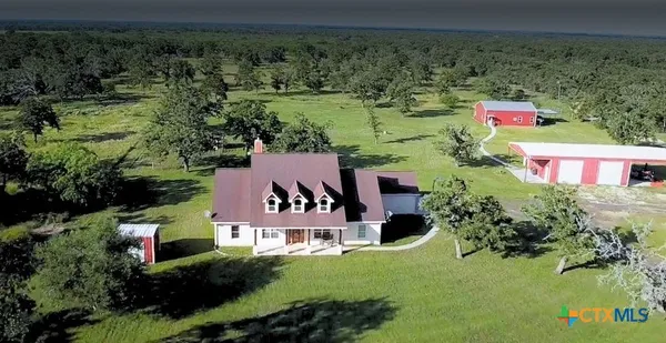 an aerial view of a house with a yard