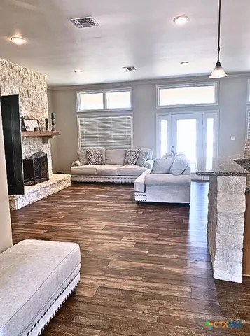 a living room with furniture fireplace and flat screen tv