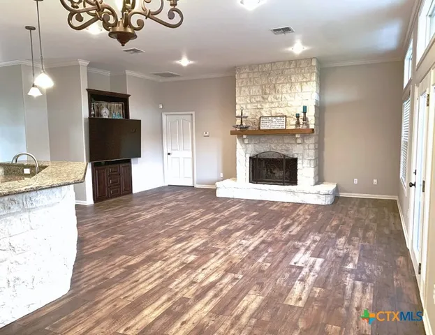 a view of a kitchen with a sink a refrigerator and a fireplace