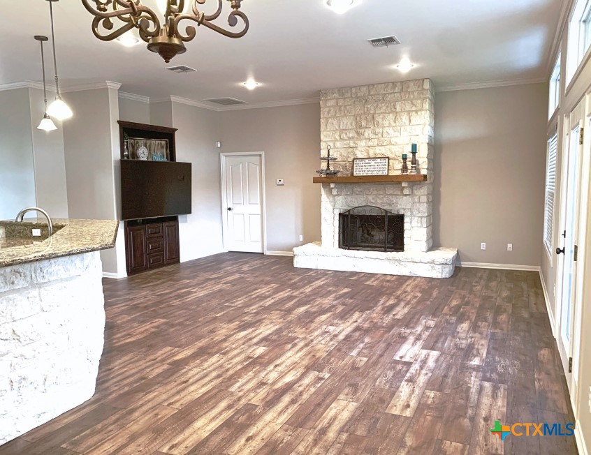 949 Abrameit Road Goliad, TX 77963 - Photo 13 of 30 a view of a kitchen with a sink a refrigerator and a fireplace