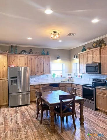 a kitchen with a table and chairs in it