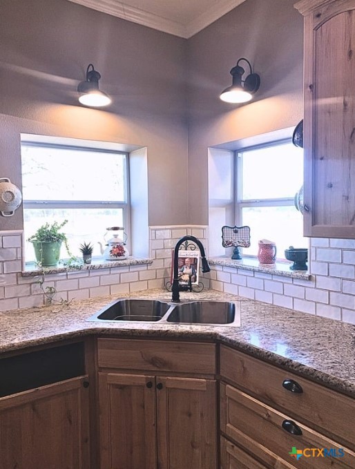 949 Abrameit Road Goliad, TX 77963 - Photo 28 of 30 a kitchen with granite countertop a sink and a window